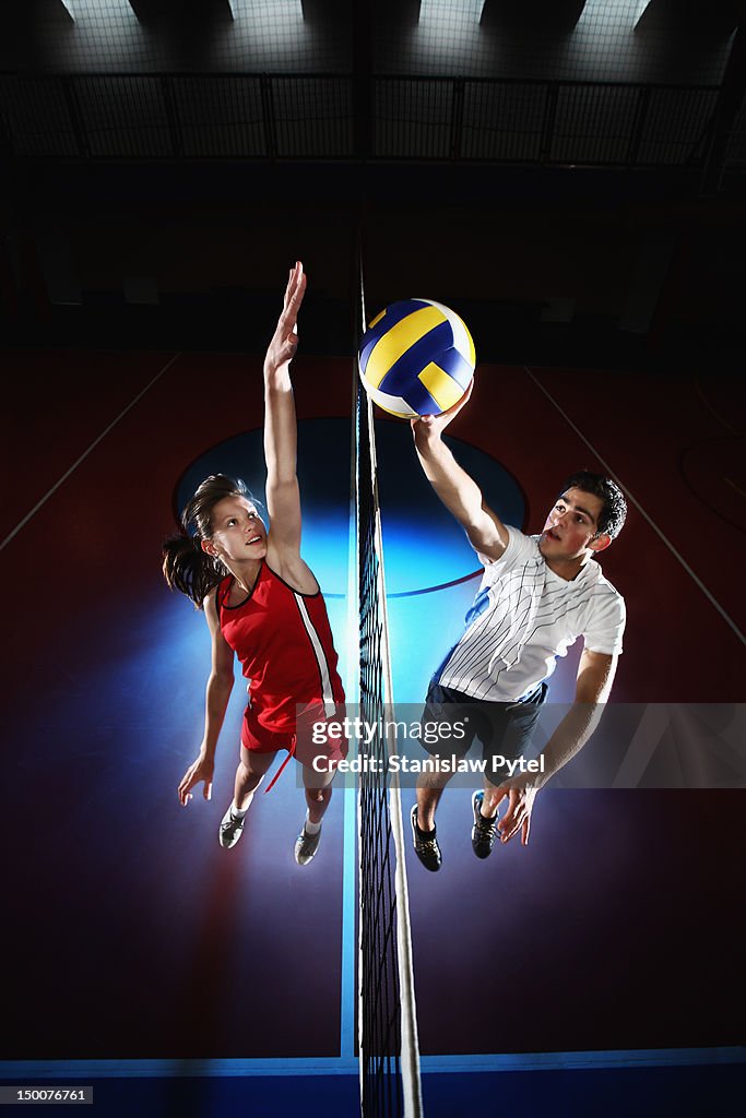 Girl and boy playing volleyball