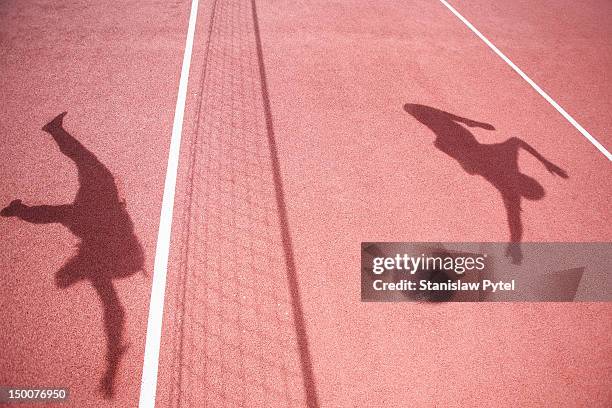 shadows of athletes playing volleyball - volleyball sport fotografías e imágenes de stock