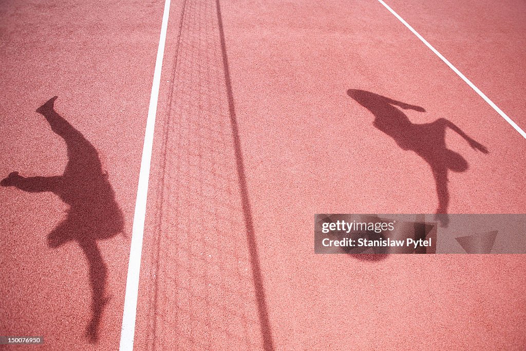 Shadows of athletes playing volleyball