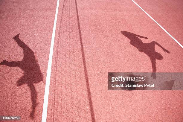 shadows of athletes playing volleyball - volleyball sport stock pictures, royalty-free photos & images