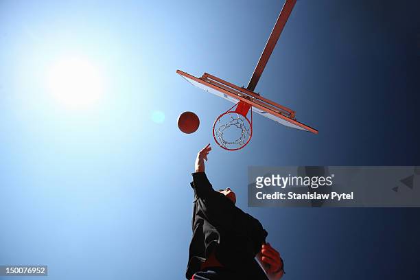 man throwing basketball ball to basket - streetball stock pictures, royalty-free photos & images