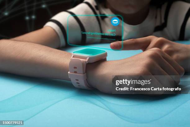 caucasian girl receives notifications on smart swatch - smartphone hologram stock pictures, royalty-free photos & images