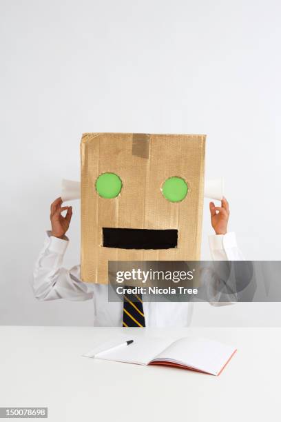 school boy wearing a robot head - boy robot head stock pictures, royalty-free photos & images