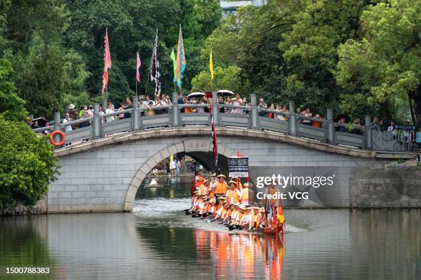 Participants compete in a dragon boat race to celebrate the Dragon Boat Festival on June 22, 2023 in Guangzhou, Guangdong Province of China. A series...