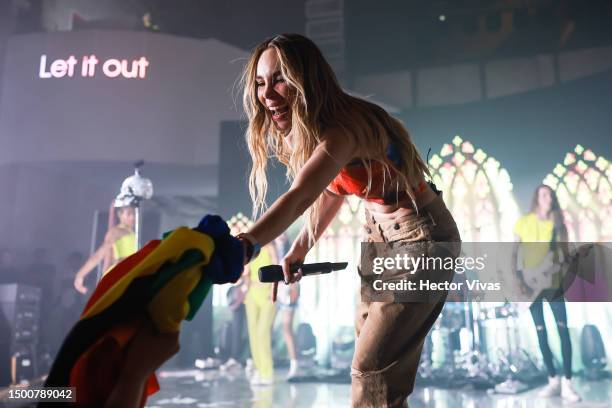 Singer Belinda takes a Pride flag during the Pride event by Calvin Klein at Lago Algo Restaurant on June 22, 2023 in Mexico City, Mexico.