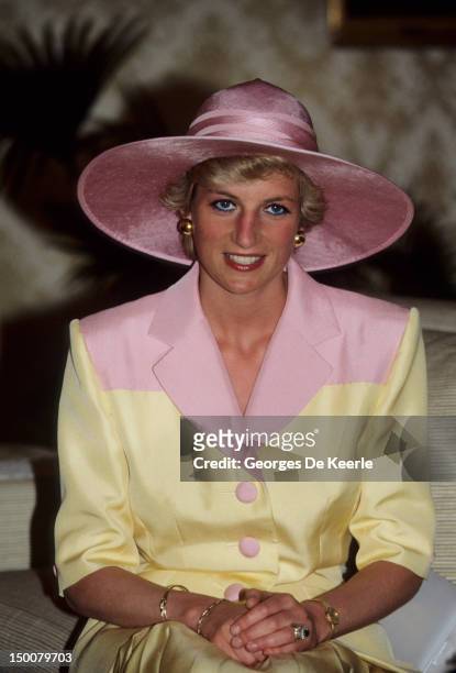 Princess Diana wearing a Catherine Walker suit with a hat by Philip Somerville on a visit to the Yaounde Deaf and Dumb School, Cameroon on March 1990.