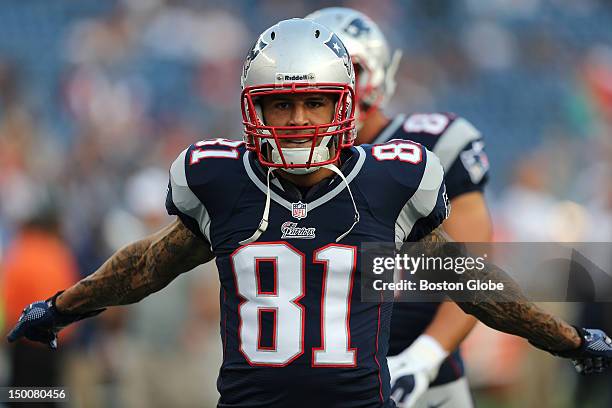 New England Patriots tight end Aaron Hernandez loosens up during pre game warmups before a preseason exhibition game against the New Orleans Saints...