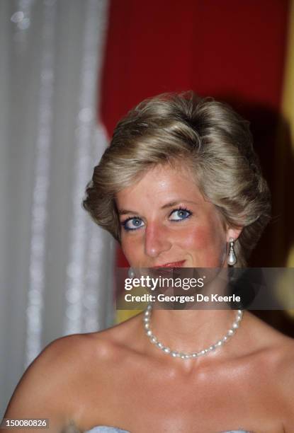 The Princess of Wales attends a banquet at the President's palace in Yaounde, Cameroon, wearing a blue Catherine Walker dress, March 1990.