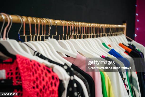 hanger with clothes in the store - damenmode stock-fotos und bilder