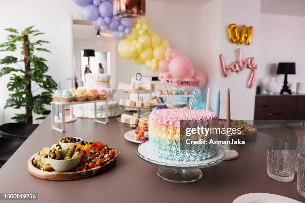 delicious  and beautiful party food on a dining table before a gender reveal party - baby shower party stock pictures, royalty-free photos & images