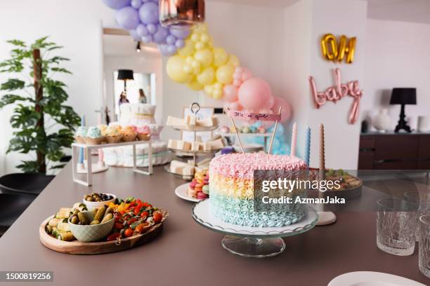 delicious and beautiful party food on a dining table before a gender reveal party - baby shower table decorations stock pictures, royalty-free photos & images