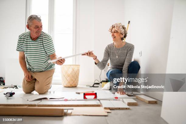 mature couple enjoying at home together - young at heart stock pictures, royalty-free photos & images