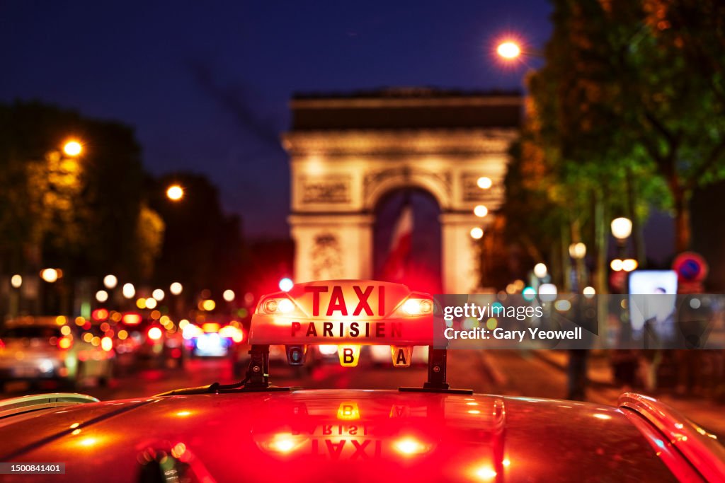 Neon taxi sign by the Arc de Triomphe