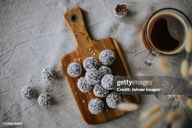 coffee and balls covered with coconut - coconut biscuits stock pictures, royalty-free photos & images