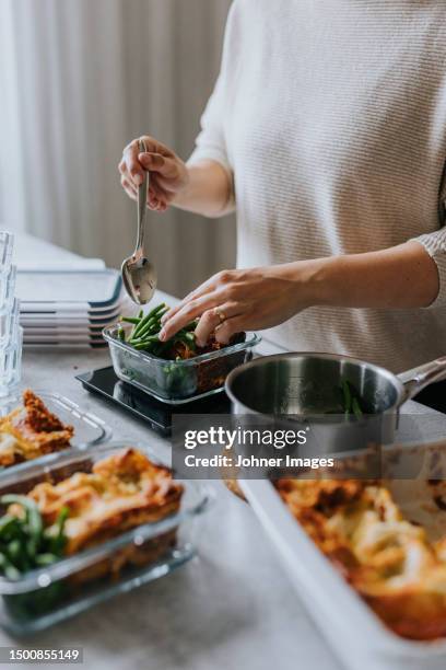 woman weighing lunch boxes as part of healthy meal prep - lasagne stock pictures, royalty-free photos & images