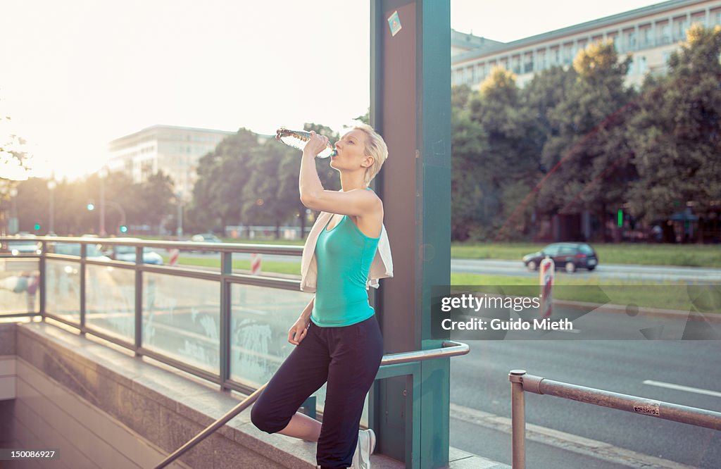 Woman drinking water after sport.