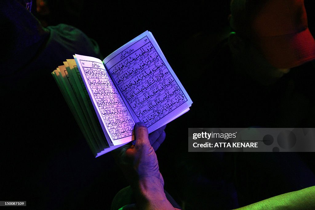 An Iranian Shiite Muslim reads the Koran