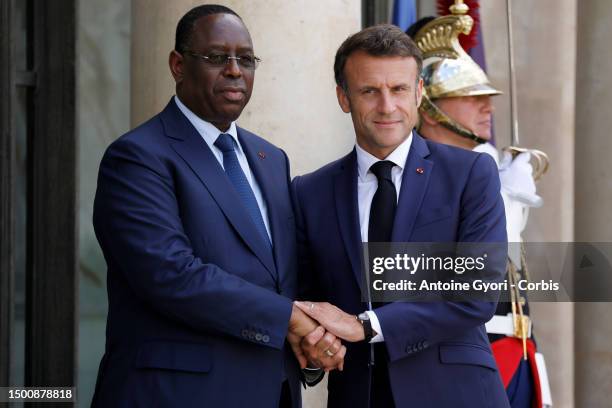 French President Emmanuel Macron greets Senegal's President Macky Sall for their meeting at the Elysee Palace, amid the New Global Financial Pact...