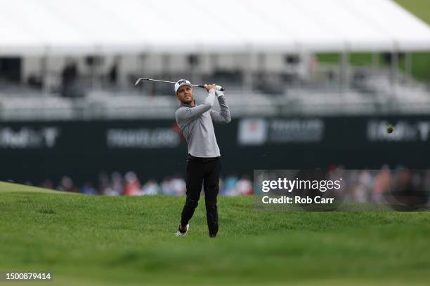 Eric Cole of the United States plays an approach shot on the second hole during the second round of the Travelers Championship at TPC River Highlands...