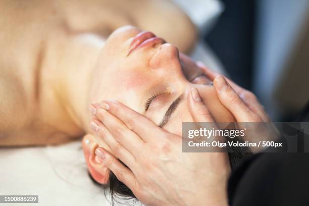 high angle view of woman enjoying facial massage at spa,bulgaria - massaggio del viso foto e immagini stock