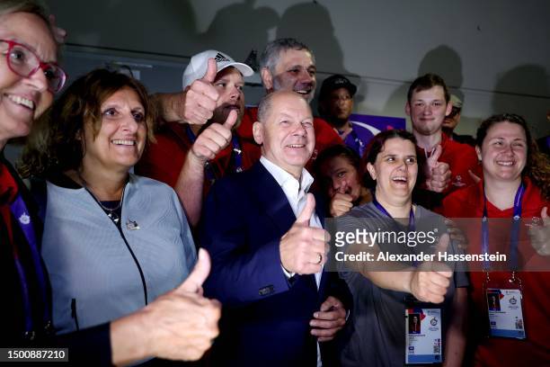 German Chancellor Olaf Scholz and his wife Britta Ernst attend the Handball match between India and Azerbabajian at Horst-Körber-Sportzentrum during...