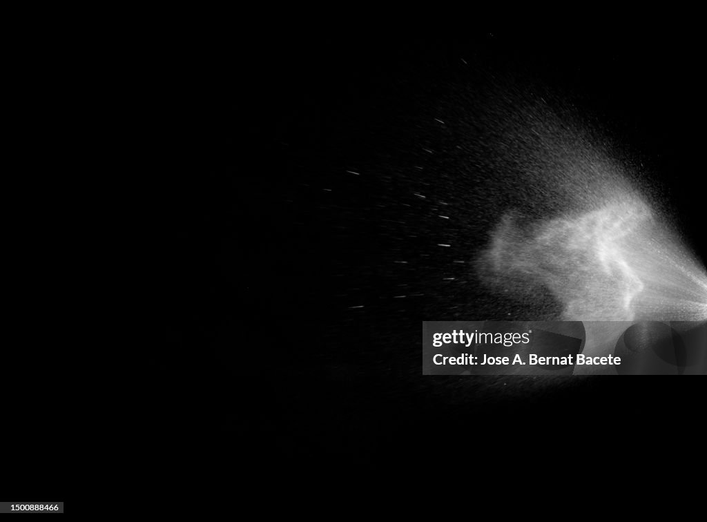 Jet and cloud of water spray drops on a black background.