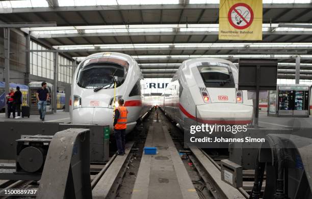 An employee of German state rail carrier Deutsche Bahn polishes the front panel of an ICE high speed train at Hauptbahnhof main railway station on...