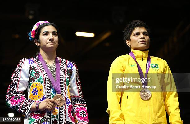 Mavzuna Chorieva of Tajikistan and Bronze medalists Adriana Araujo of Brazil are seen during the medal ceremony for the Women's Light Boxing final...