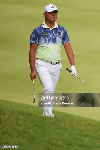 Si Woo Kim of South Korea walks the tenth hole after breaking his club during the second round of the Travelers Championship at TPC River Highlands...