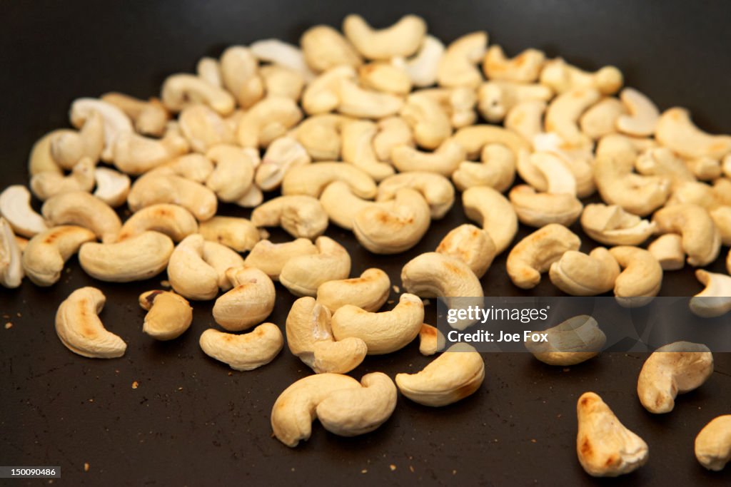 Toasting cashew nuts in a pan