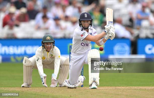 England batter Heather Knight reverse sweeps for runs watched by Alyssa Healy during day two of the LV= Insurance Women's Ashes Test match between...