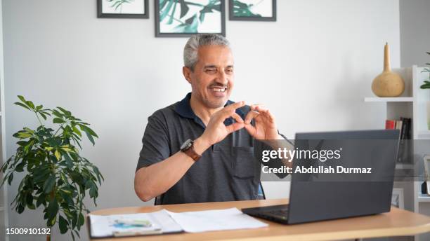 man video chatting with laptop uses sign language - deaf signing stock pictures, royalty-free photos & images