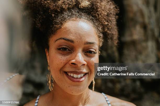 close-up portrait of a beautiful mixed race woman with freckles - mixed age range stock-fotos und bilder