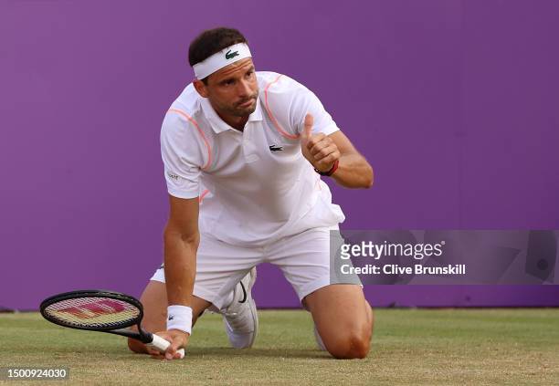 Grigor Dimitrov of Bulgaria reacts after slipping against Carlos Alcaraz of Spain during the Men's Singles Quarter Final match on Day Five of the...
