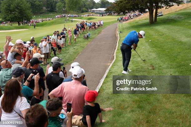 Viktor Hovland of Norway plays an approach shot on the first hole as fans look on during the second round of the Travelers Championship at TPC River...