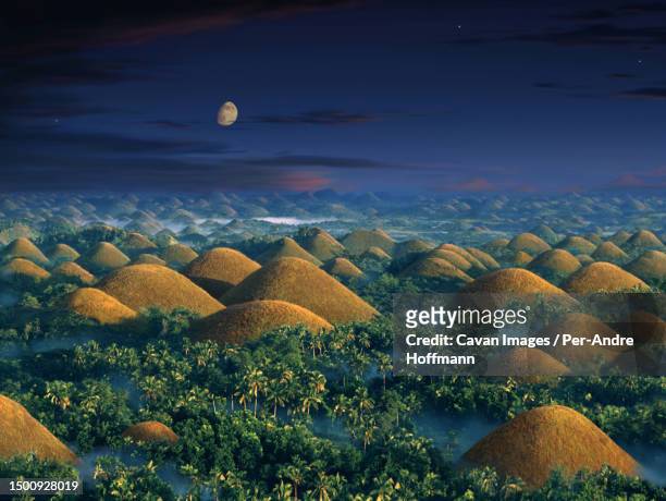 sunrise over the chocolate hills (near carmen) - bohol philippines stock pictures, royalty-free photos & images