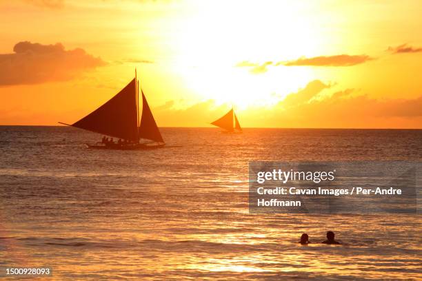 couple at sunset, boracay - outrigger stock pictures, royalty-free photos & images