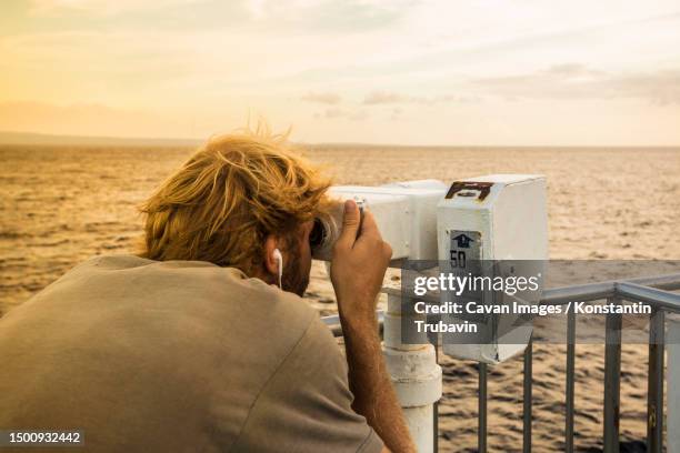 young man at cruise deck ship and binocular - looking through an object stock pictures, royalty-free photos & images