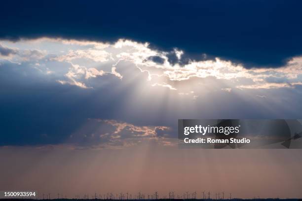 rays of light shining through dark clouds. god rays. sun rays - prayer book fotografías e imágenes de stock