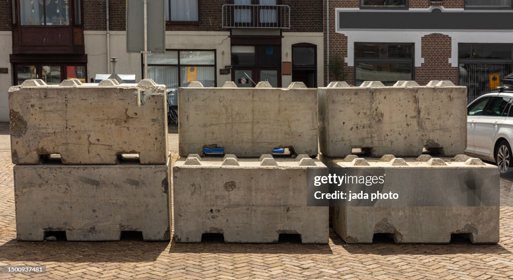 Large concrete blocks stand in the street