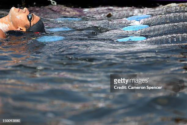 Oussama Mellouli of Tunisia reacts after the Men's Marathon 10km swim on Day 14 of the London 2012 Olympic Games at Hyde Park on August 10, 2012 in...