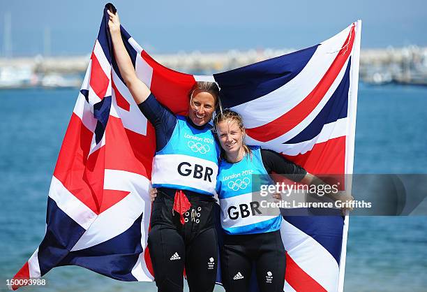 Hannah Mills and Saskia Clark of Great Britain celebrate after finishing second and taking the silver medal in the 470 Women's Class Sailing on Day...