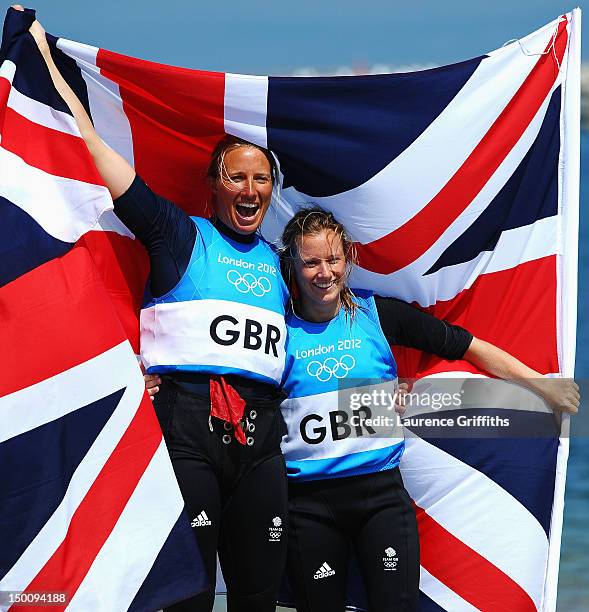 Hannah Mills and Saskia Clark of Great Britain celebrate after finishing second and taking the silver medal in the 470 Women's Class Sailing on Day...