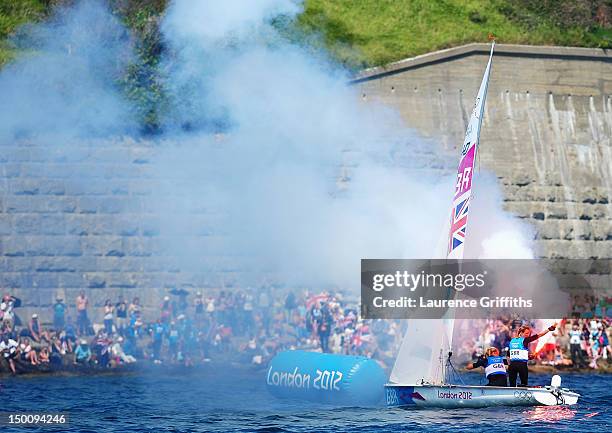 Hannah Mills and Saskia Clark of Great Britain celebrate after finishing second and taking the silver medal in the 470 Women's Class Sailing on Day...