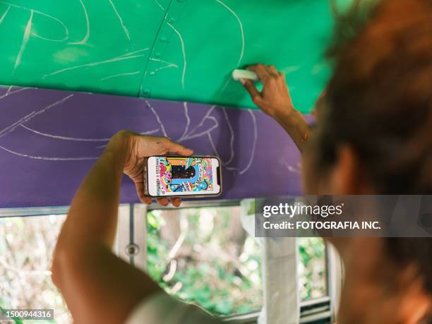 mid adult iranian woman artist painting  mural inside party bus - fotografia photos stock pictures, royalty-free photos & images