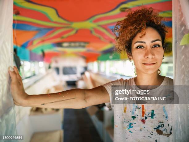 mid adult iranian woman artist painting  mural inside party bus - iranian people stock pictures, royalty-free photos & images