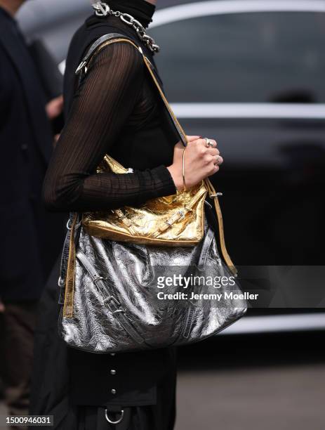 Fashion Week guest is seen wearing two Givenchy bags a silver and gold one, black mesh top, black tank top, black skirt and black destroyed jeans...