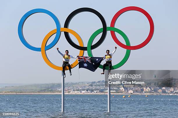 Mathew Belcher and Malcolm Page of Australia celebrate in the Olympic rings after winning gold in the Men's 470 Sailing on Day 14 of the London 2012...