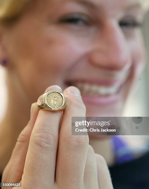 Olympic gold medalist Kayla Harrison poses with the O.C. Tanner Inspiration Award, a 14K gold commemorative ring, after being presented with it by...