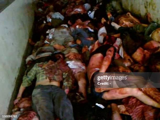 An image grab taken from a video uploaded on YouTube on August 7, 2012 allegedly shows 45 bodies, some of them handcuffed and tortured, lying at the...